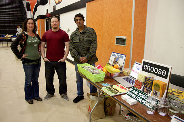 Emily, Alex and Rishi, all post-9/11 veterans, prepare to talk to students about military recruitment and their experiences in the Army and Marine Corps, at the Pittsburg High School career fair on May 25. (Credit: Siri Margerin)